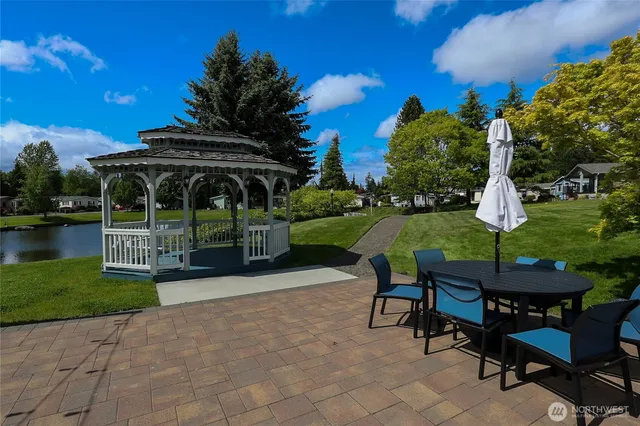 a view of a table and chairs in patio with a yard