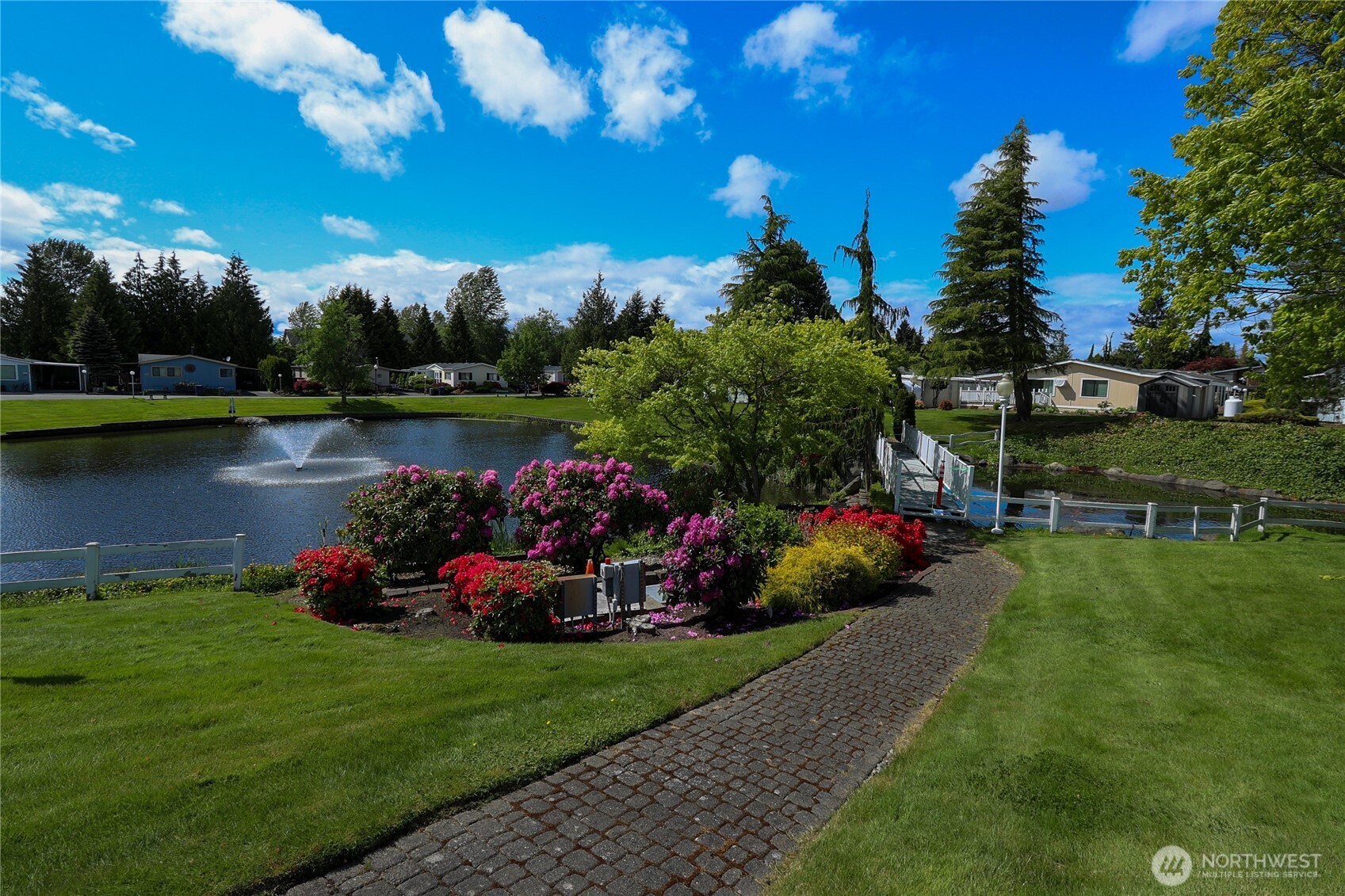 1427 100th Street Southwest, Unit 57 Everett, WA 98204 - Photo 35 of 38 a view of a lake with a big yard and potted plants