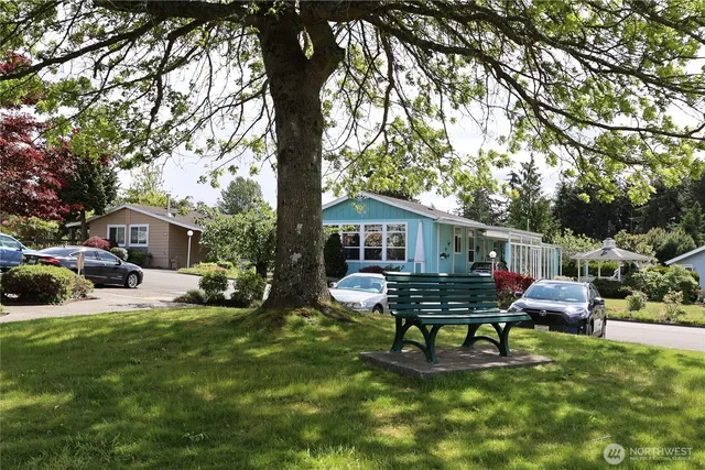 a view of a house with backyard and sitting area