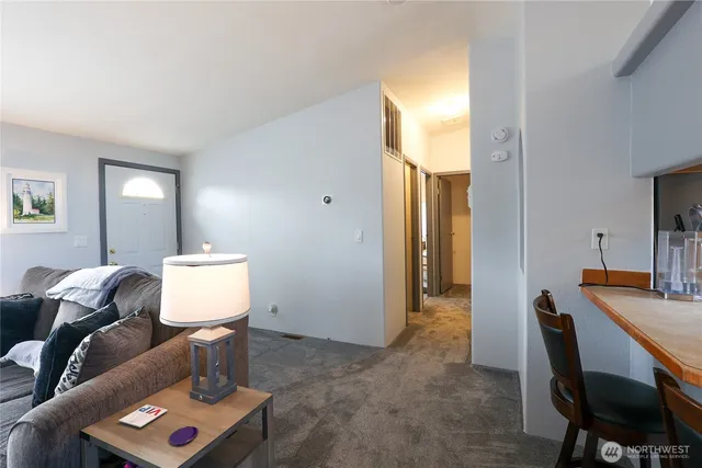 a view of a workspace with furniture and a window