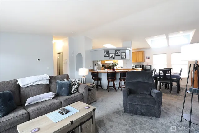 a living room with furniture dining table and a window