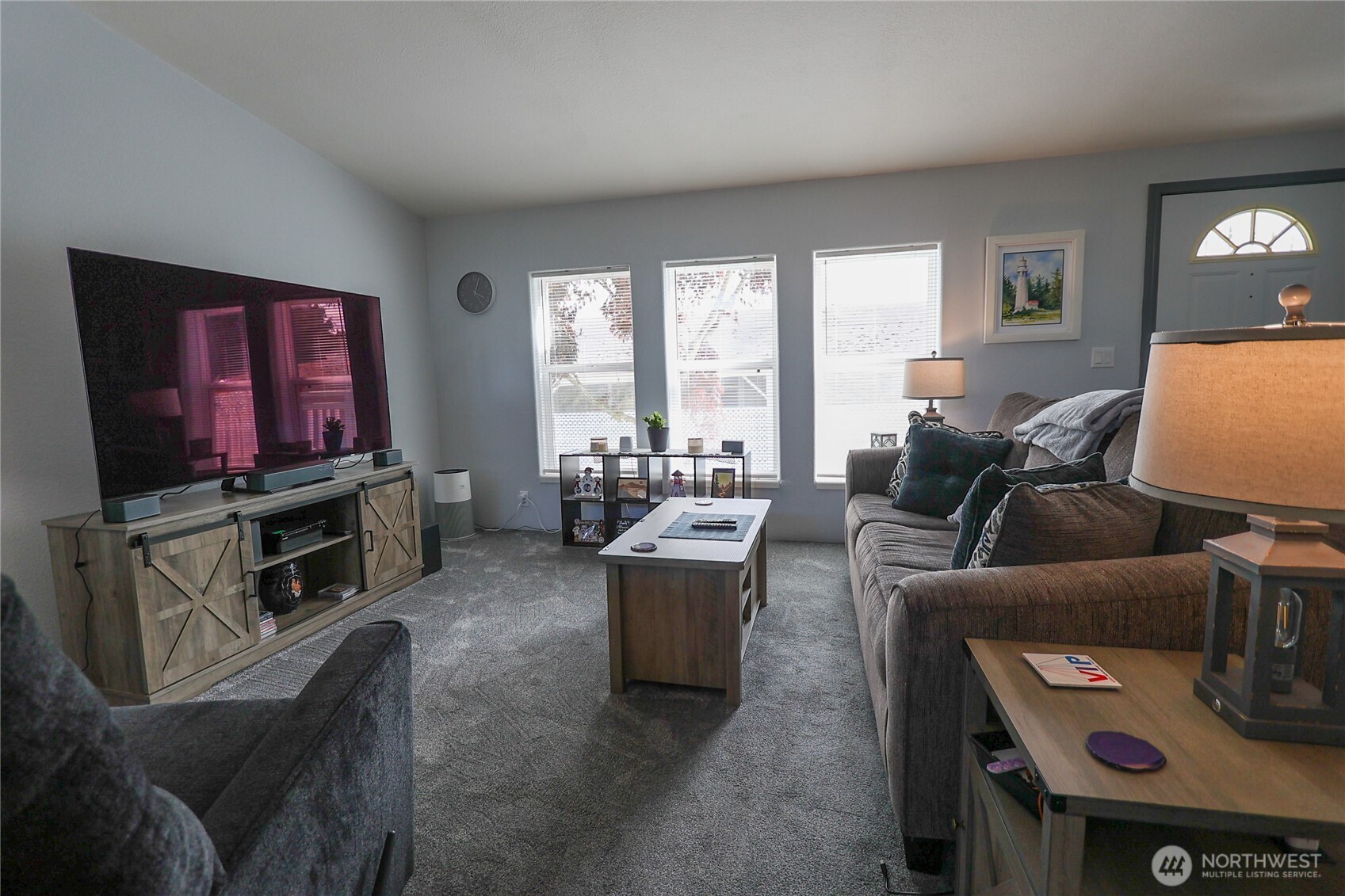 1427 100th Street Southwest, Unit 57 Everett, WA 98204 - Photo 9 of 38 a living room with furniture and a flat screen tv