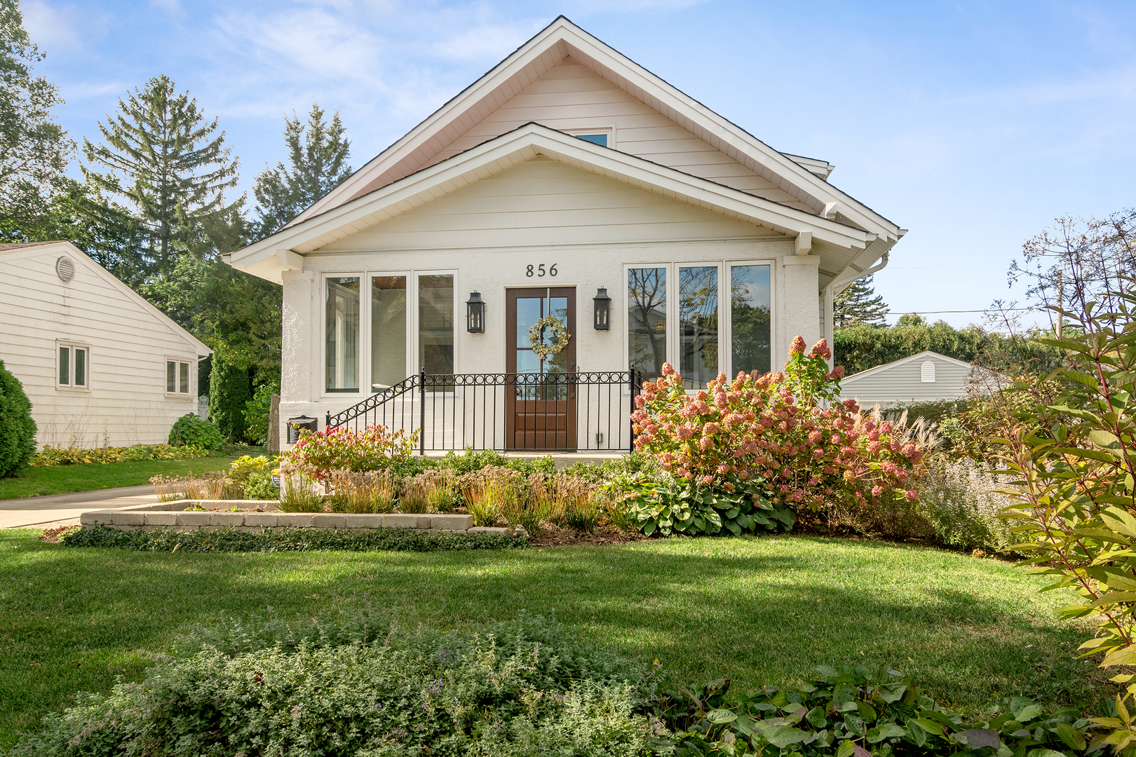 a front view of a house with a yard and porch