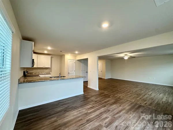 a view of kitchen with wooden floor and electronic appliances