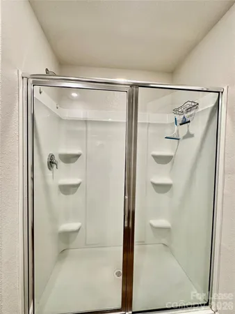 a bathroom with a glass shower door