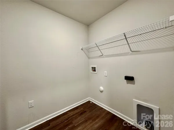 a view of a room with wooden floor