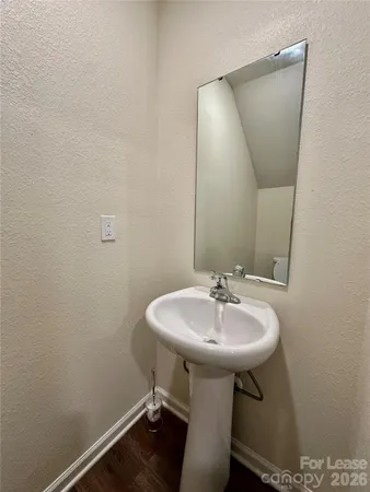 a bathroom with a sink a mirror and a toilet