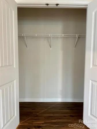 a view of room with wooden floor