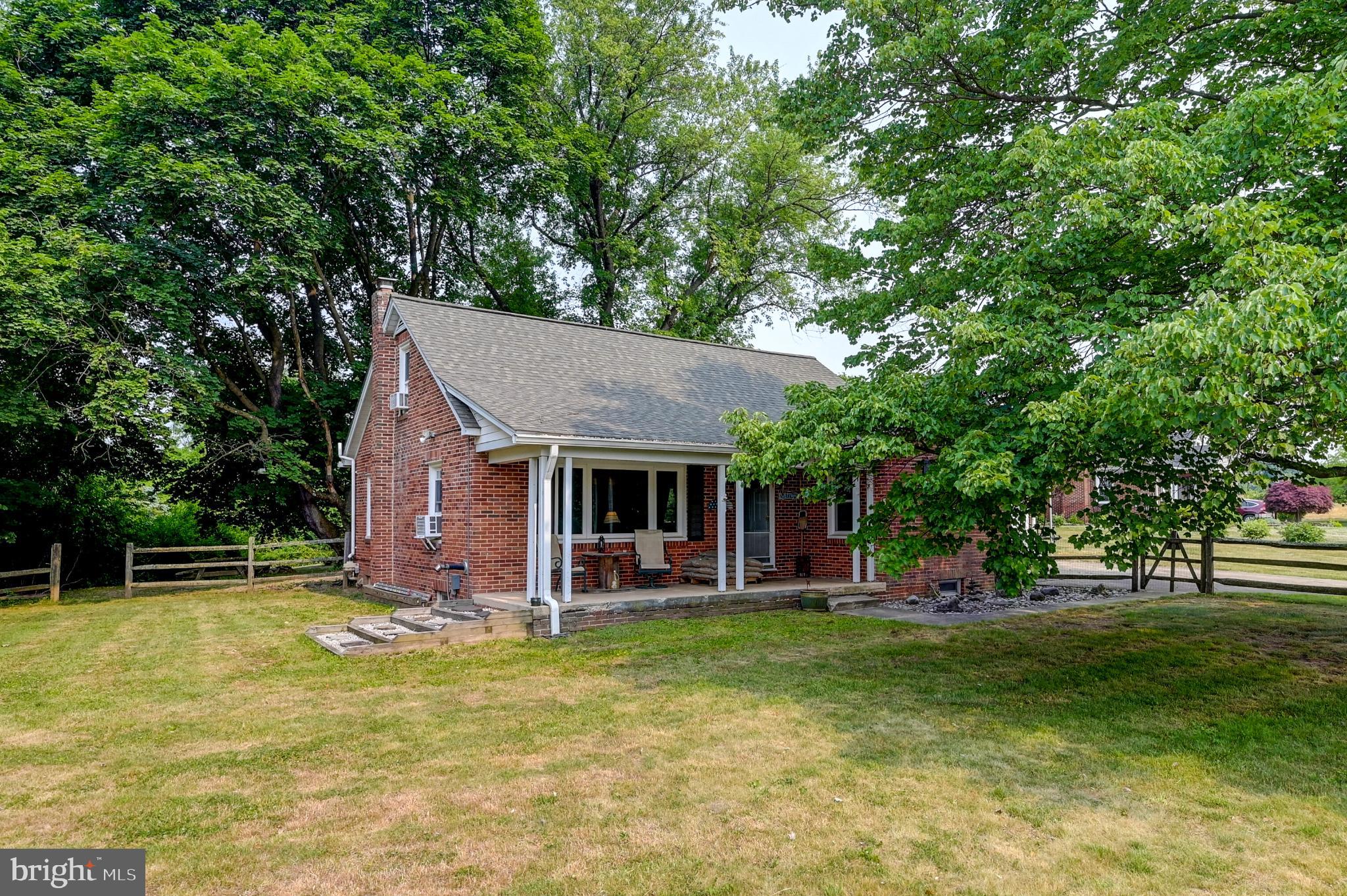 5371 Long Corner Road White Hall, MD 21161 - Photo 3 of 30 Charming brick home nestled in lush greenery.