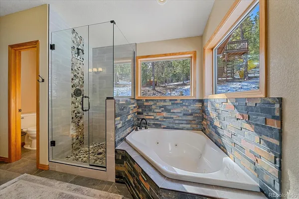 a bathroom with a bathtub and shower