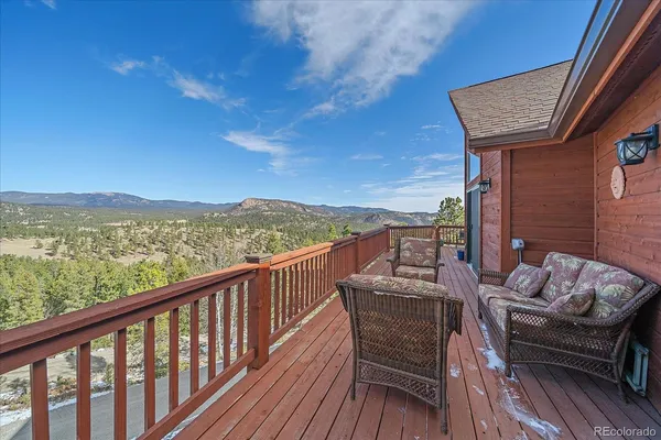 a view of a balcony with an outdoor seating