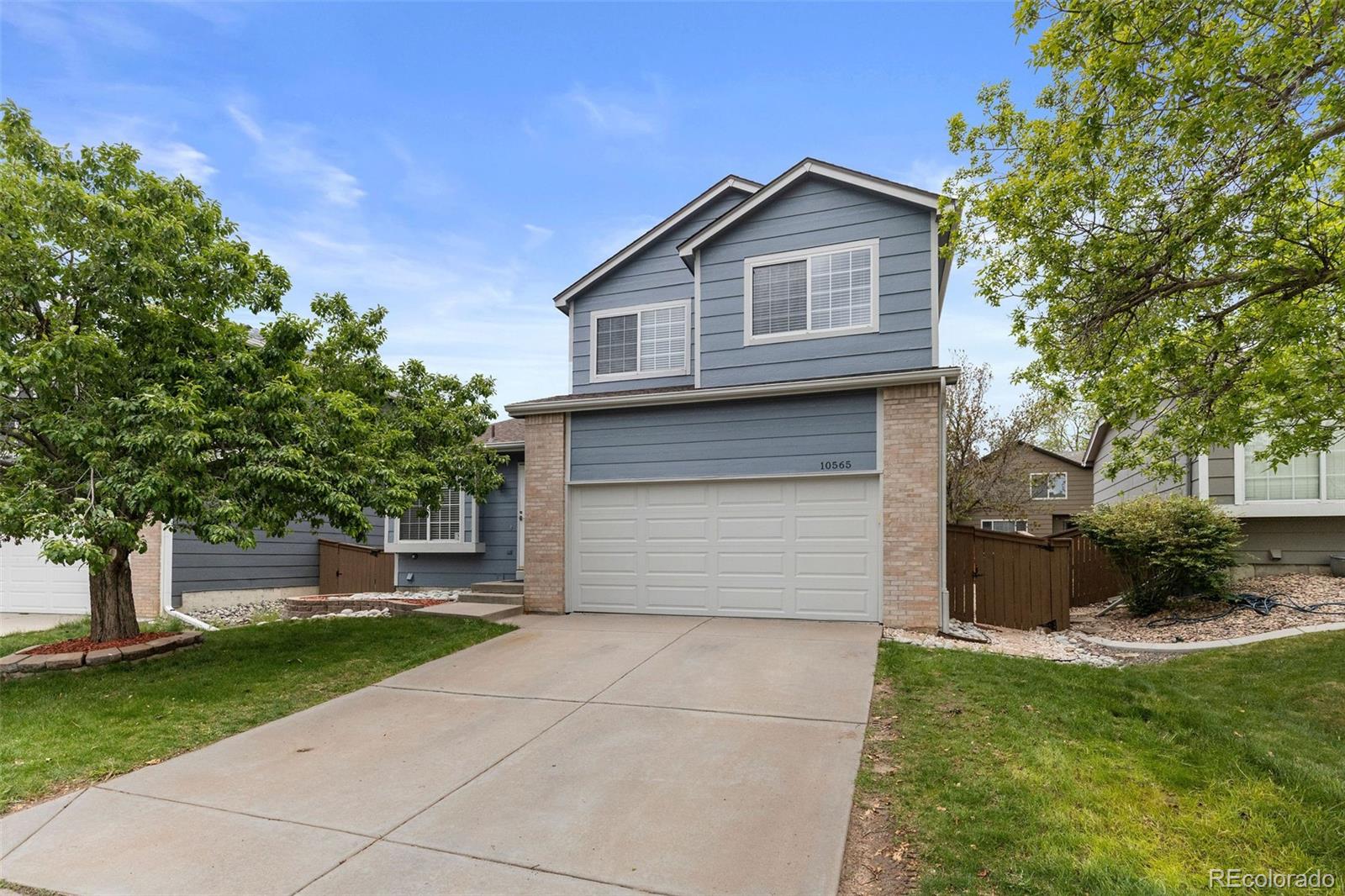 10565 Hyacinth Place Highlands Ranch, CO 80129 - Photo 33 of 33 a front view of a house with a yard and garage