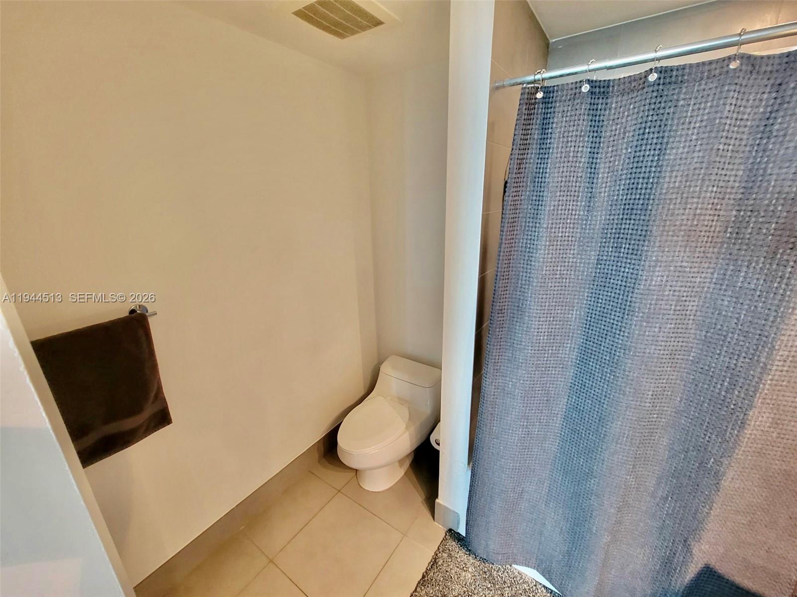 92 Southwest 3rd Street, Unit 1808 Miami, FL 33130 - Photo 11 of 45 a bathroom with a toilet and a shower