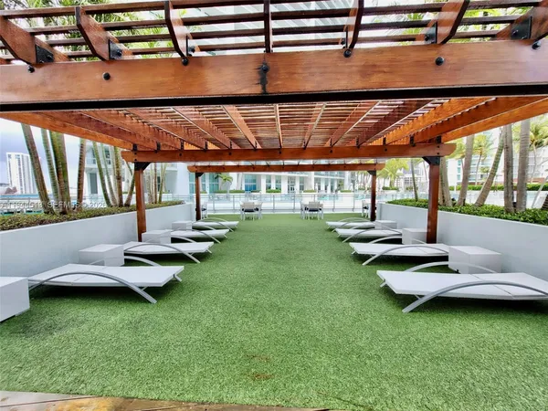 a view of swimming pool with a yard and sitting area