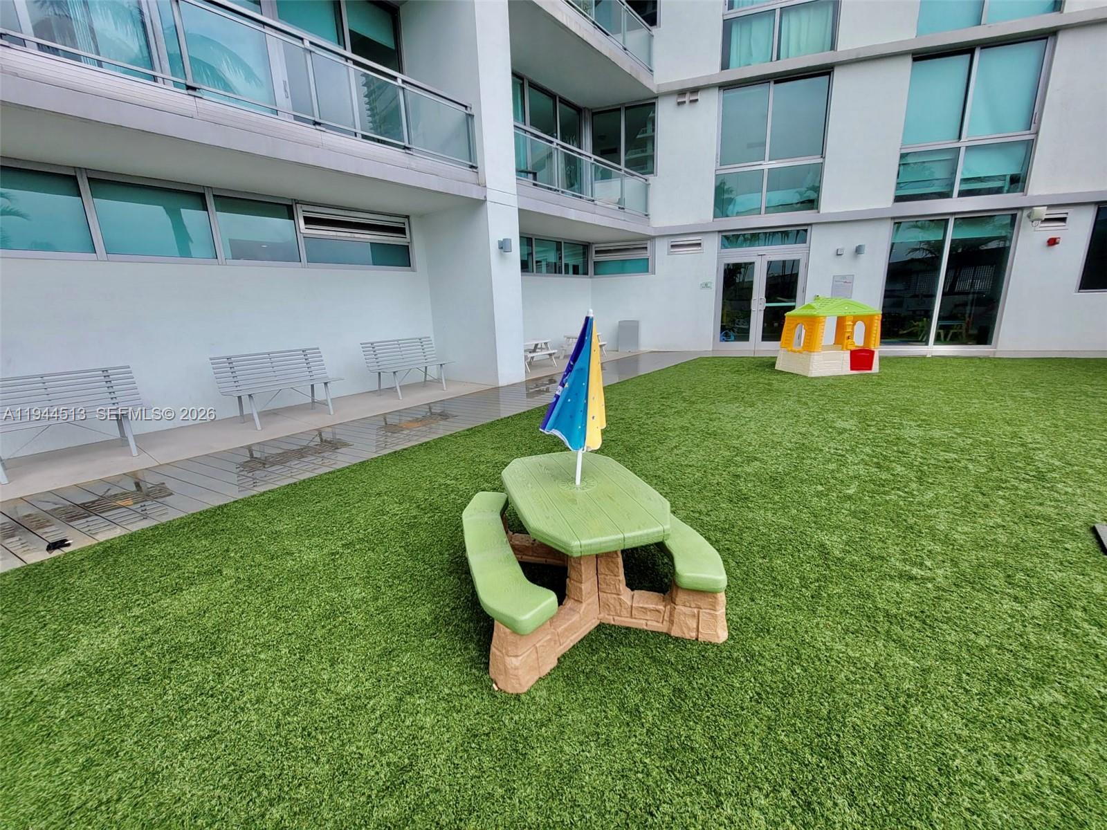 92 Southwest 3rd Street, Unit 1808 Miami, FL 33130 - Photo 30 of 45 a front view of a house with garden and outdoor seating