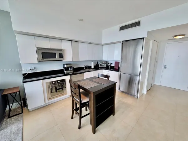 a kitchen with a stove a refrigerator and a sink