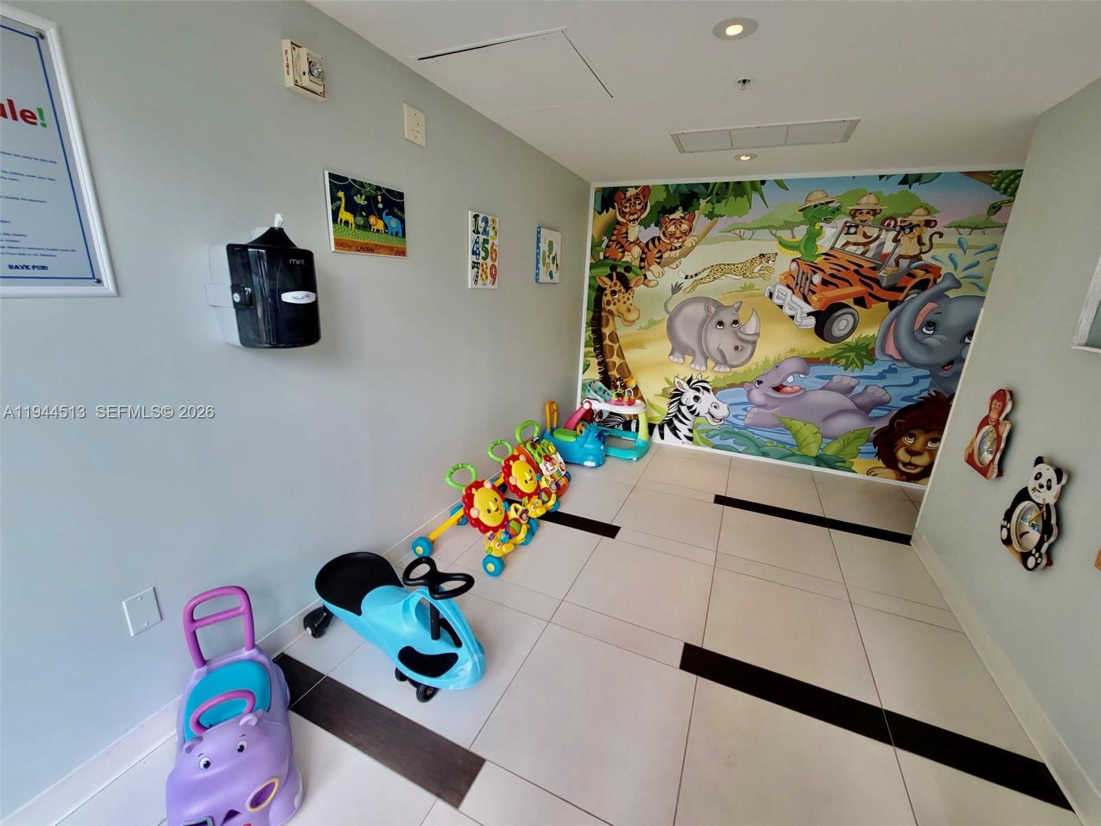 92 Southwest 3rd Street, Unit 1808 Miami, FL 33130 - Photo 33 of 45 a room with toys and wall paintings on the wall