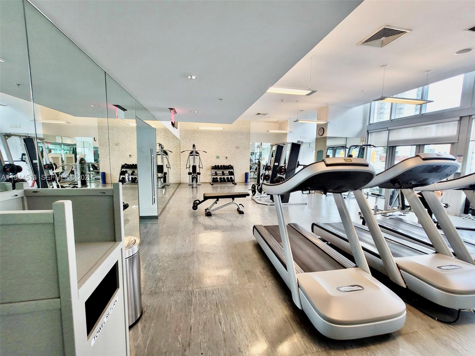 92 Southwest 3rd Street, Unit 1808 Miami, FL 33130 - Photo 36 of 45 a living room with lots of furniture and a wooden floor