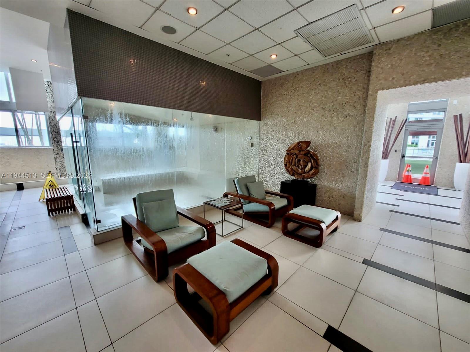 92 Southwest 3rd Street, Unit 1808 Miami, FL 33130 - Photo 39 of 45 a living room with furniture and a flat screen tv