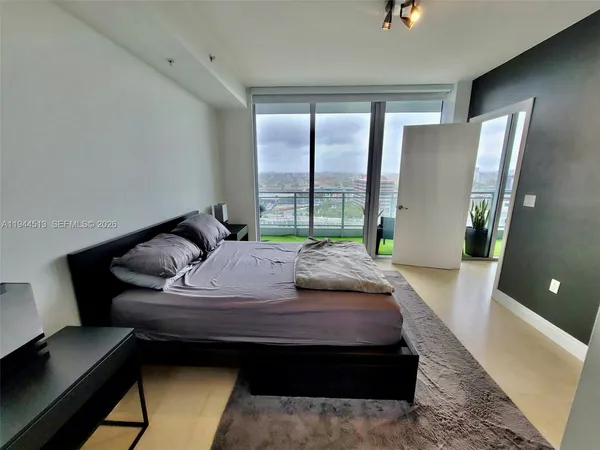 a bed sitting in a bedroom next to a window