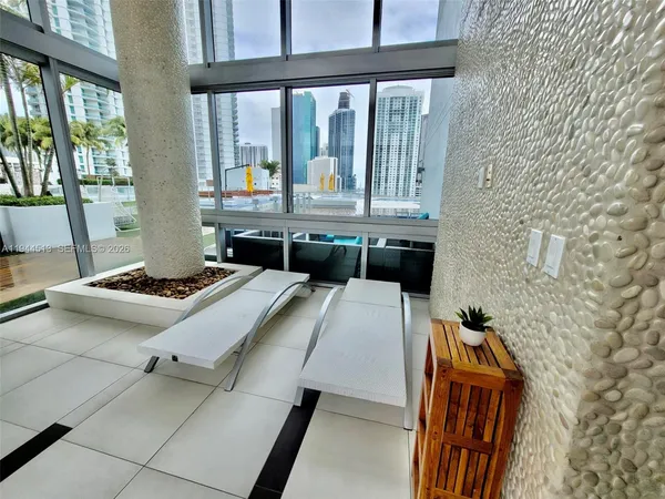 a living room with furniture a rug and a large window