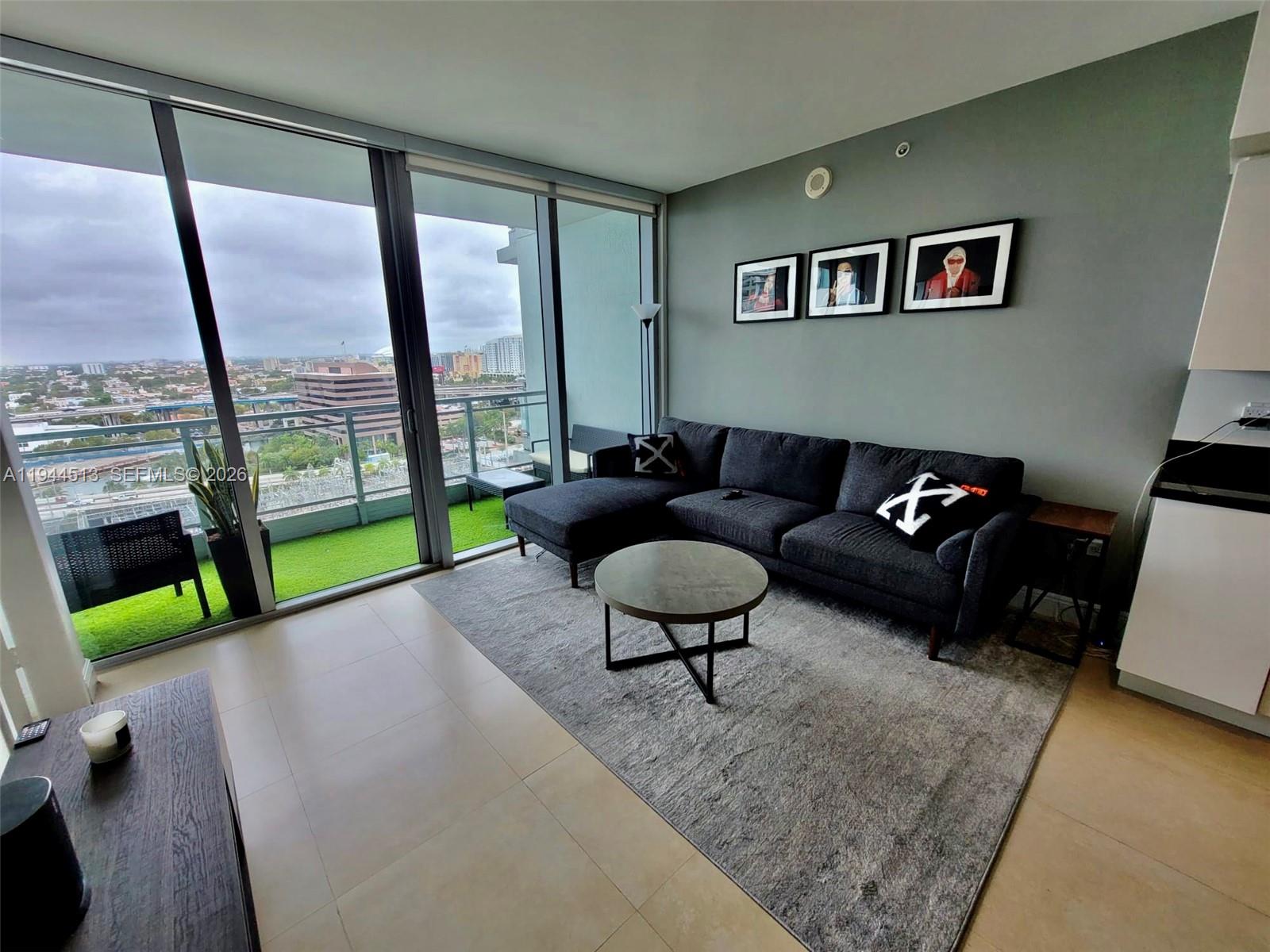 92 Southwest 3rd Street, Unit 1808 Miami, FL 33130 - Photo 6 of 45 a living room with furniture and a floor to ceiling window