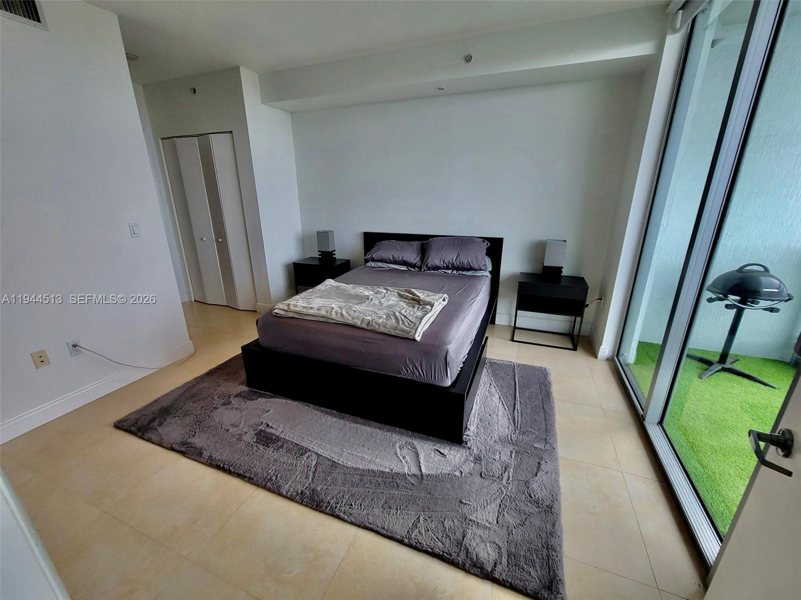 92 Southwest 3rd Street, Unit 1808 Miami, FL 33130 - Photo 9 of 45 a bedroom with a bed and a mirror on dresser