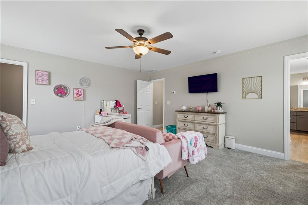 204 North Avenue Fairmount, GA 30139 - Photo 29 of 35 a bedroom with a bed and a chandelier