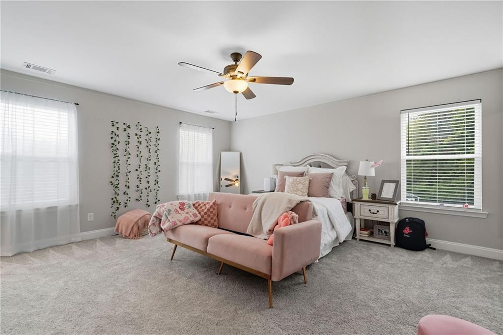 204 North Avenue Fairmount, GA 30139 - Photo 30 of 35 a spacious bedroom with a bed and a chandelier