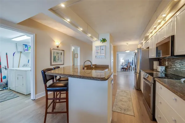 a kitchen with granite countertop lots of counter top space and furniture