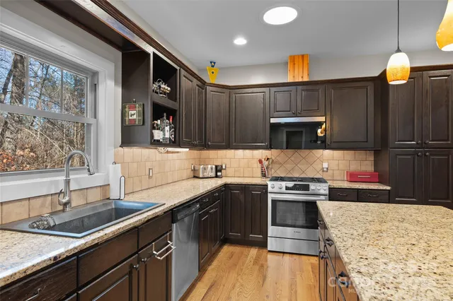 a kitchen with a sink a stove and cabinets