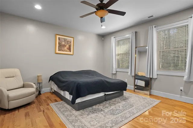 a bedroom with a bed couch and a window