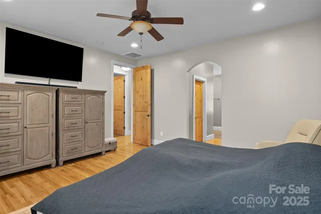 a bedroom with furniture and a flat screen tv