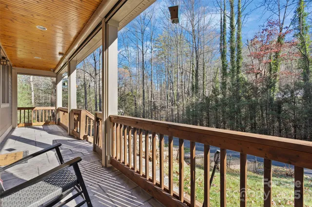 a view of roof with wooden floor and outdoor seating