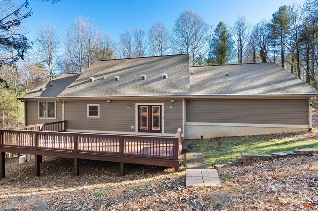 a view of a house with a yard and roof deck