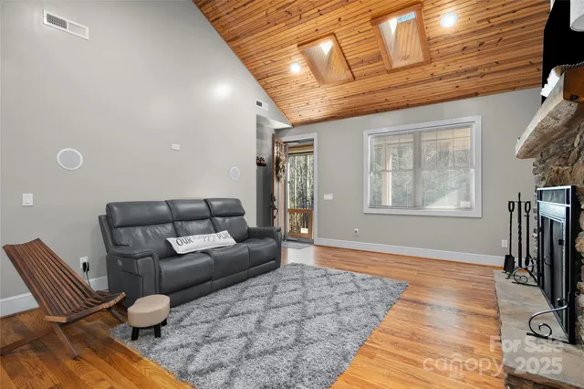 a living room with furniture a flat screen tv and a window