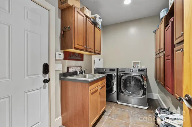 a utility room with sink dryer and washer