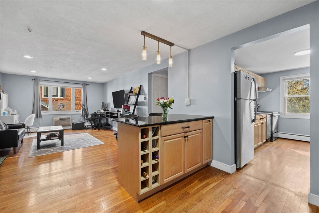 a large kitchen with stainless steel appliances granite countertop a stove and a sink