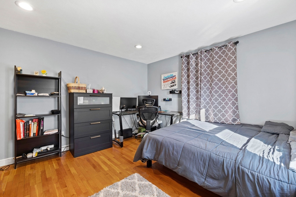 112 Decatur Street, Unit 6 Arlington, MA 02474 - Photo 12 of 16 a bedroom with a bed and furniture