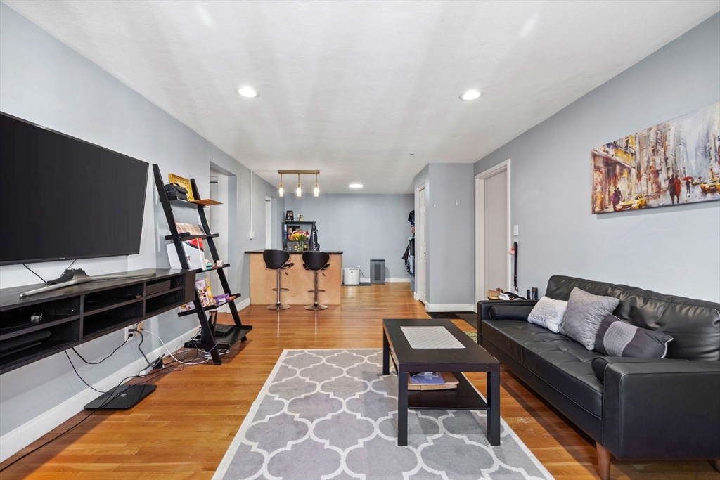 112 Decatur Street, Unit 6 Arlington, MA 02474 - Photo 4 of 16 a living room with furniture and a flat screen tv