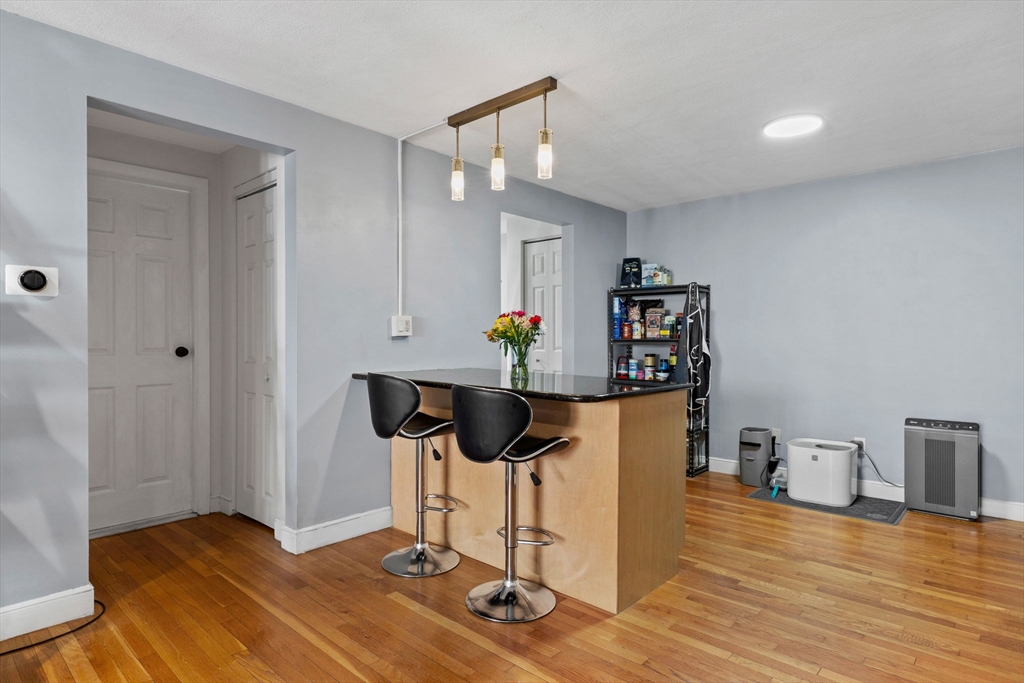 112 Decatur Street, Unit 6 Arlington, MA 02474 - Photo 7 of 16 a view of a workspace with furniture and wooden floor
