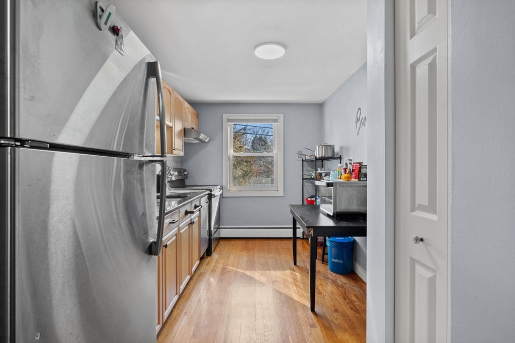 112 Decatur Street, Unit 6 Arlington, MA 02474 - Photo 8 of 16 a kitchen with refrigerator a washer and dryer