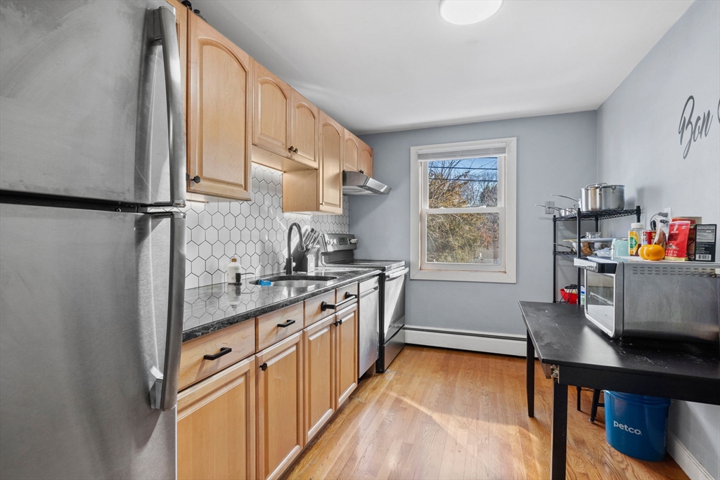 112 Decatur Street, Unit 6 Arlington, MA 02474 - Photo 9 of 16 a kitchen with stainless steel appliances a sink and a refrigerator