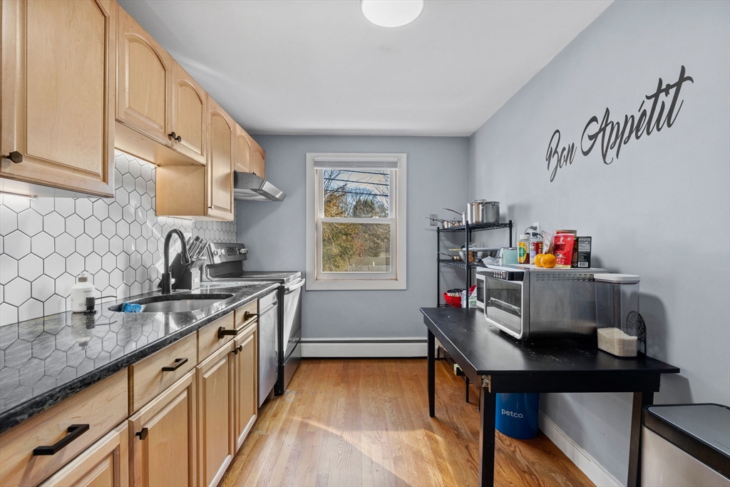 112 Decatur Street, Unit 6 Arlington, MA 02474 - Photo 10 of 16 a kitchen with a sink cabinets and window
