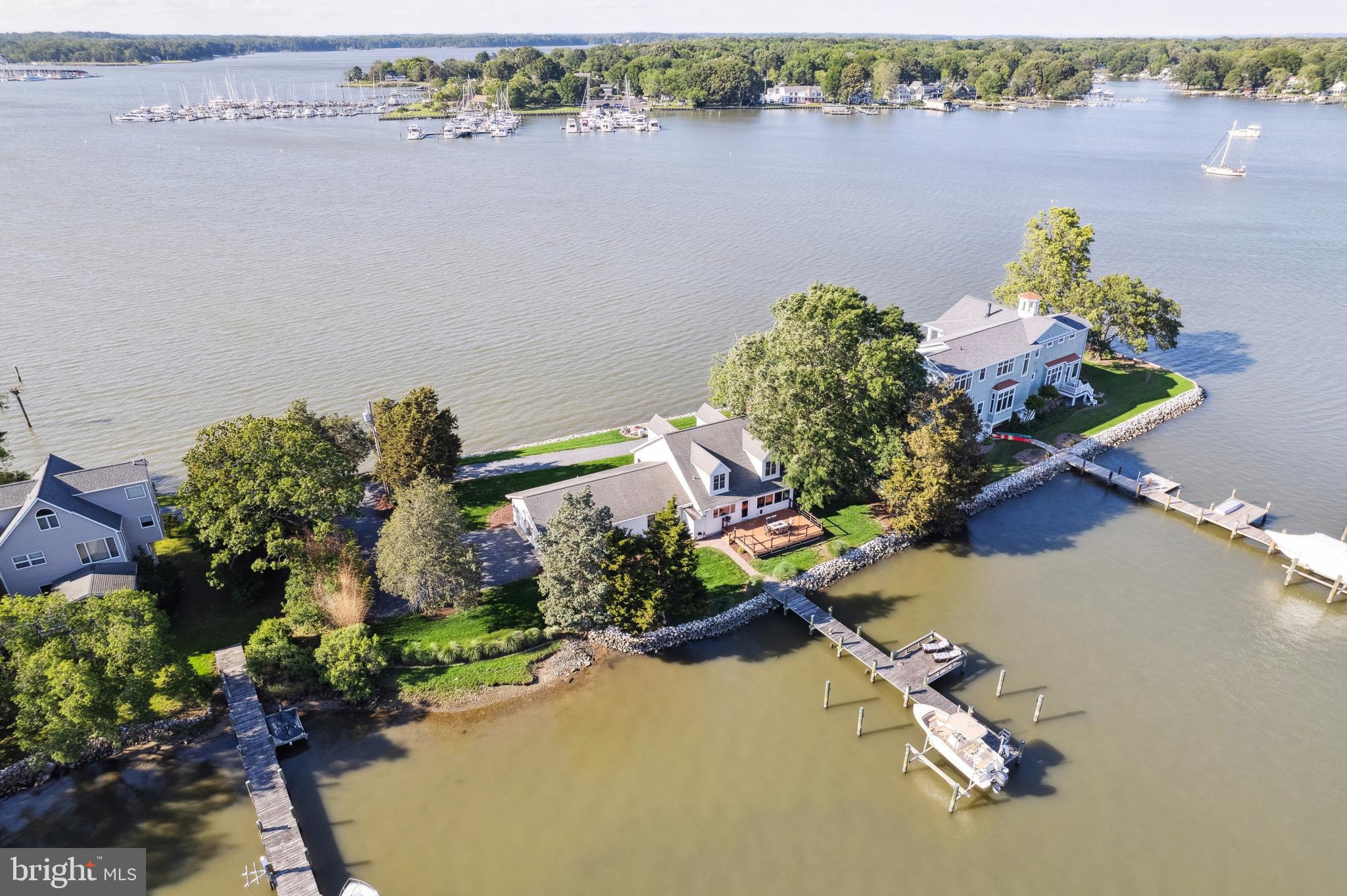 1045 Back Bay Beach Road West River, MD 20778 - Photo 14 of 33 an aerial view of a house with a lake and a garden