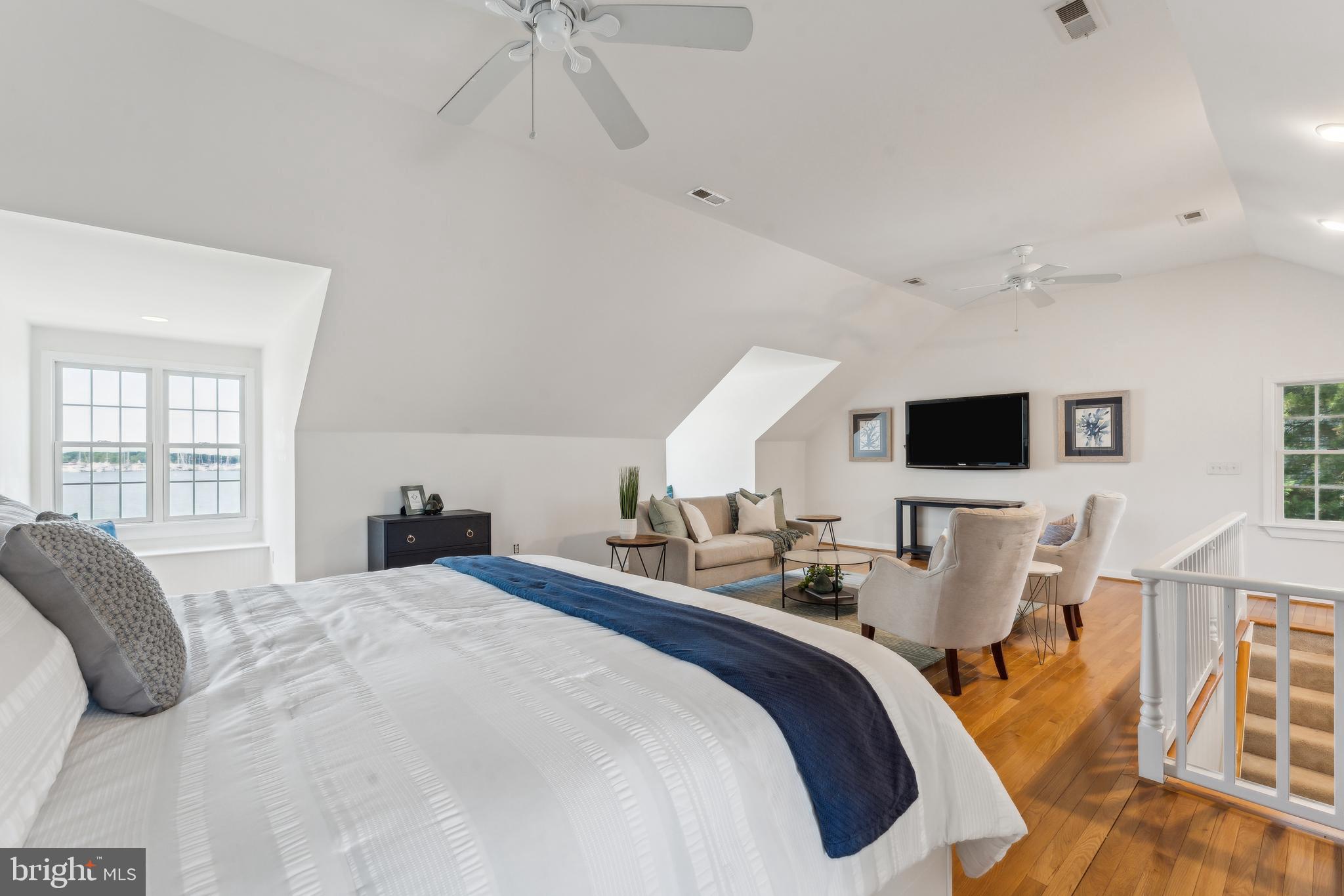 1045 Back Bay Beach Road West River, MD 20778 - Photo 26 of 33 a large bedroom with bed and wooden floor