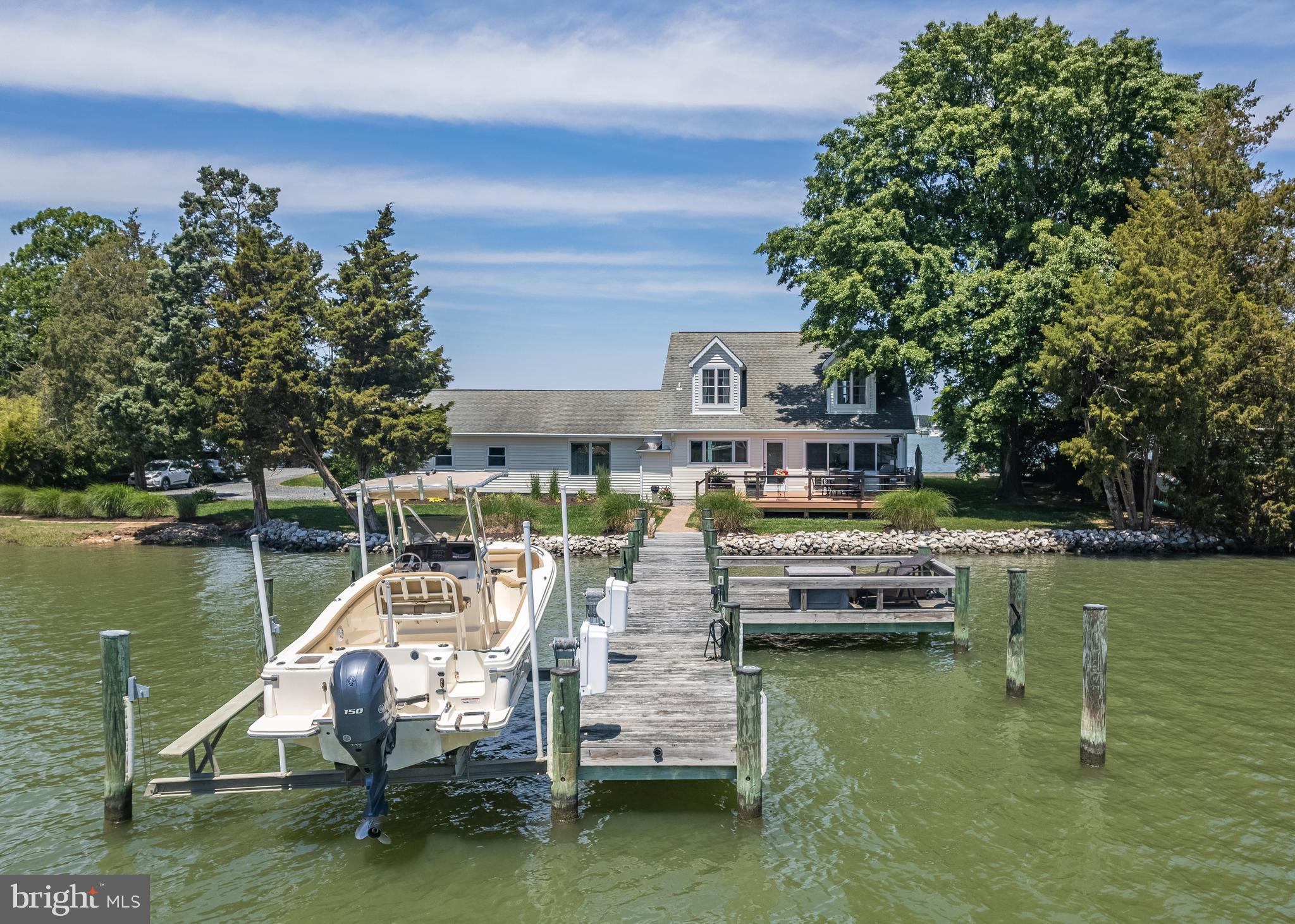 1045 Back Bay Beach Road West River, MD 20778 - Photo 3 of 33 a view of a lake with a house in the background