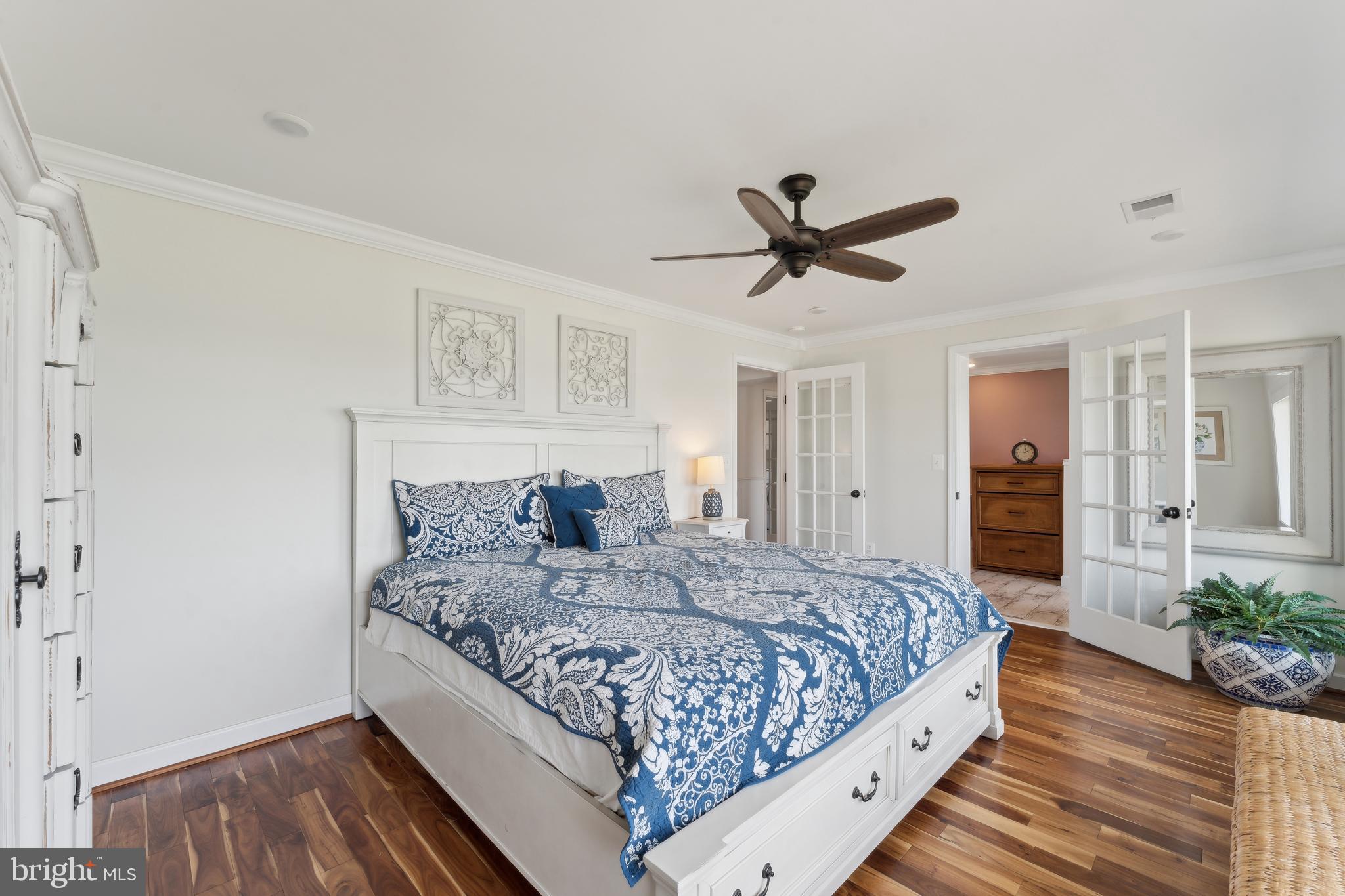 1045 Back Bay Beach Road West River, MD 20778 - Photo 6 of 33 a bedroom with a large bed chandelier and a window