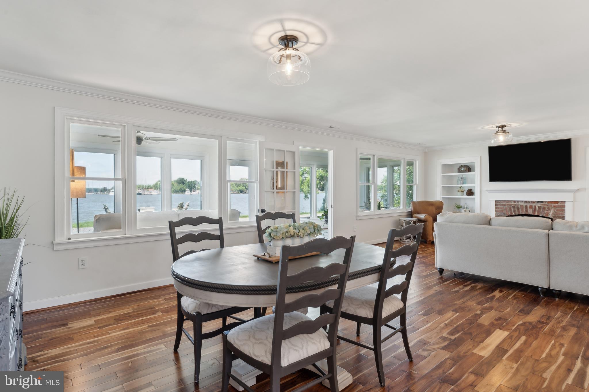 1045 Back Bay Beach Road West River, MD 20778 - Photo 9 of 33 a view of a dining room with furniture and wooden floor