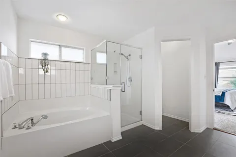 a bathroom with a double vanity sink a mirror and a shower